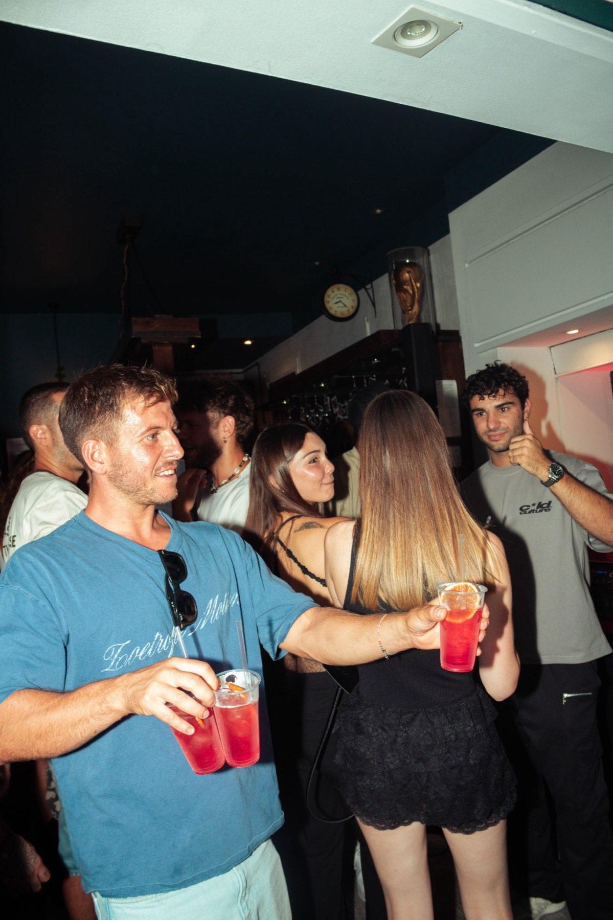 Amici brindano con drink colorati durante una serata di festa